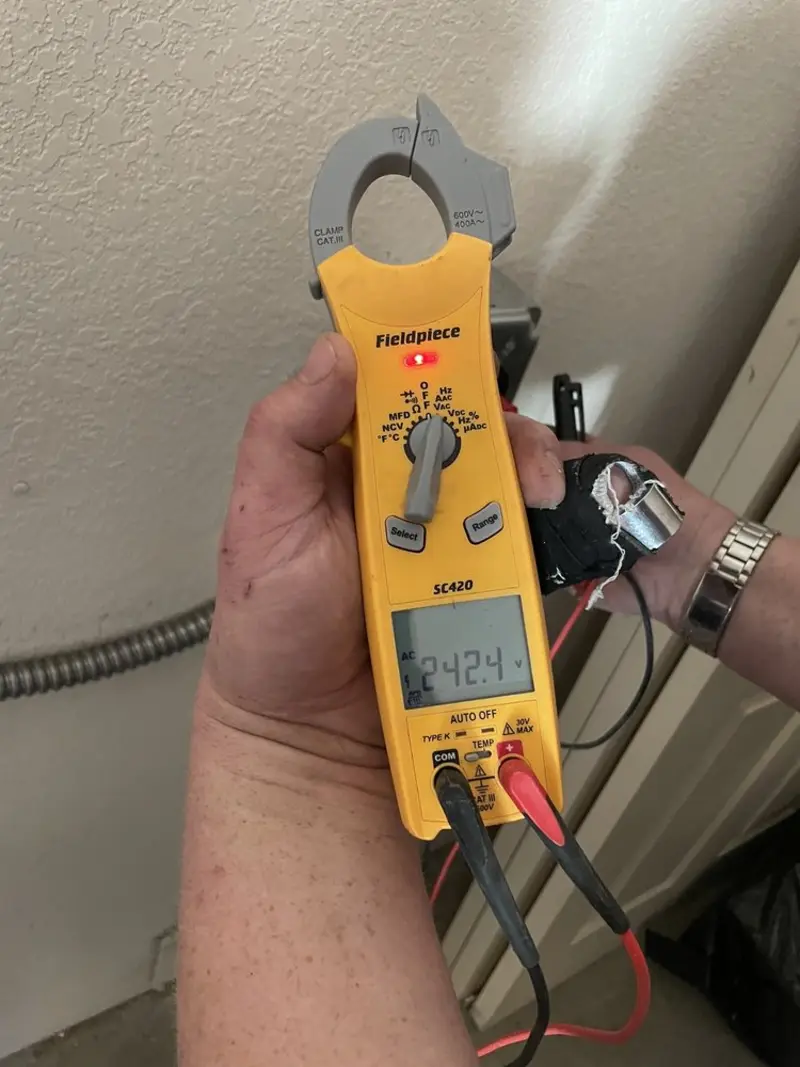 Voltage testing with clamp meter during Outlet Installation in Louisville